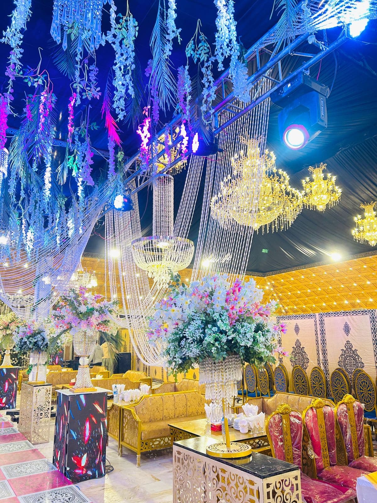 Hall with overhead chandeliers and illuminated stage